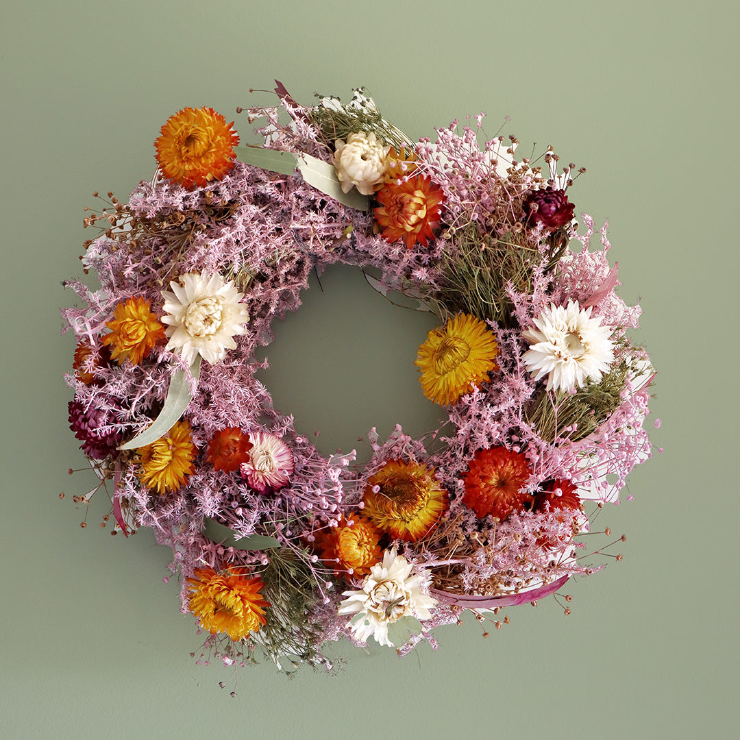 Floral wreath with a mix of flowers on a green background