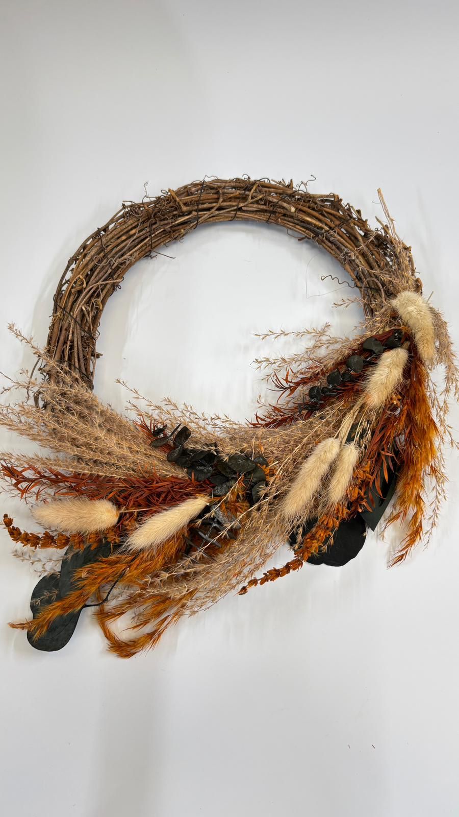 Decorative wreath with natural elements on a white background